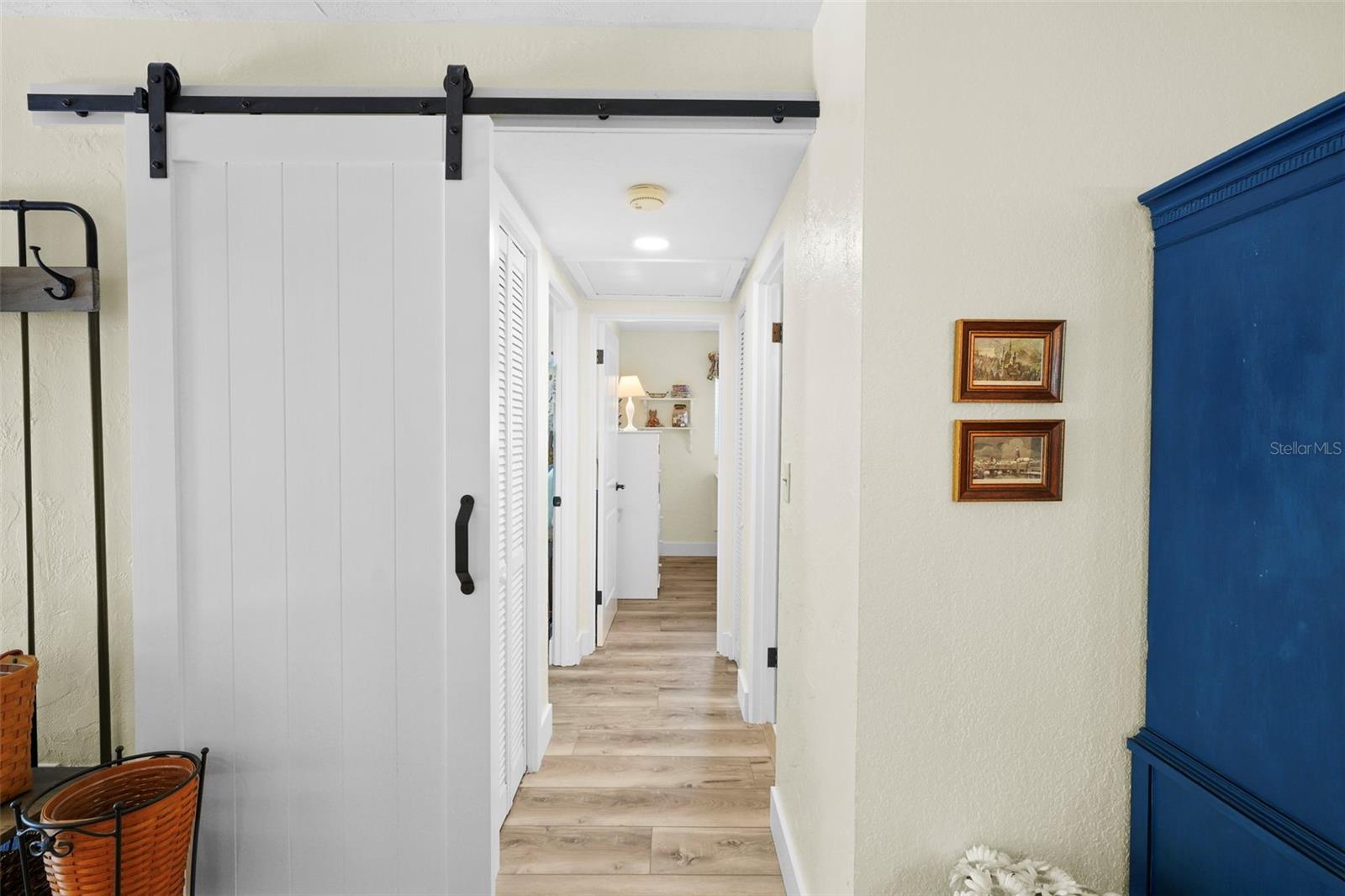 Hallway to guest bedrooms with sliding barn door