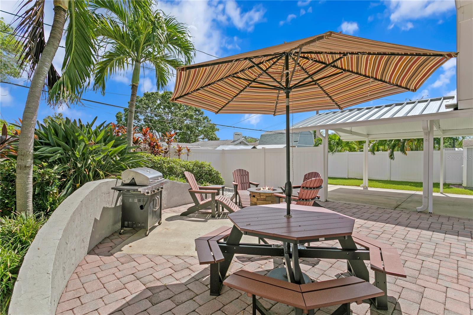 Paved outdoor seating area with firepit