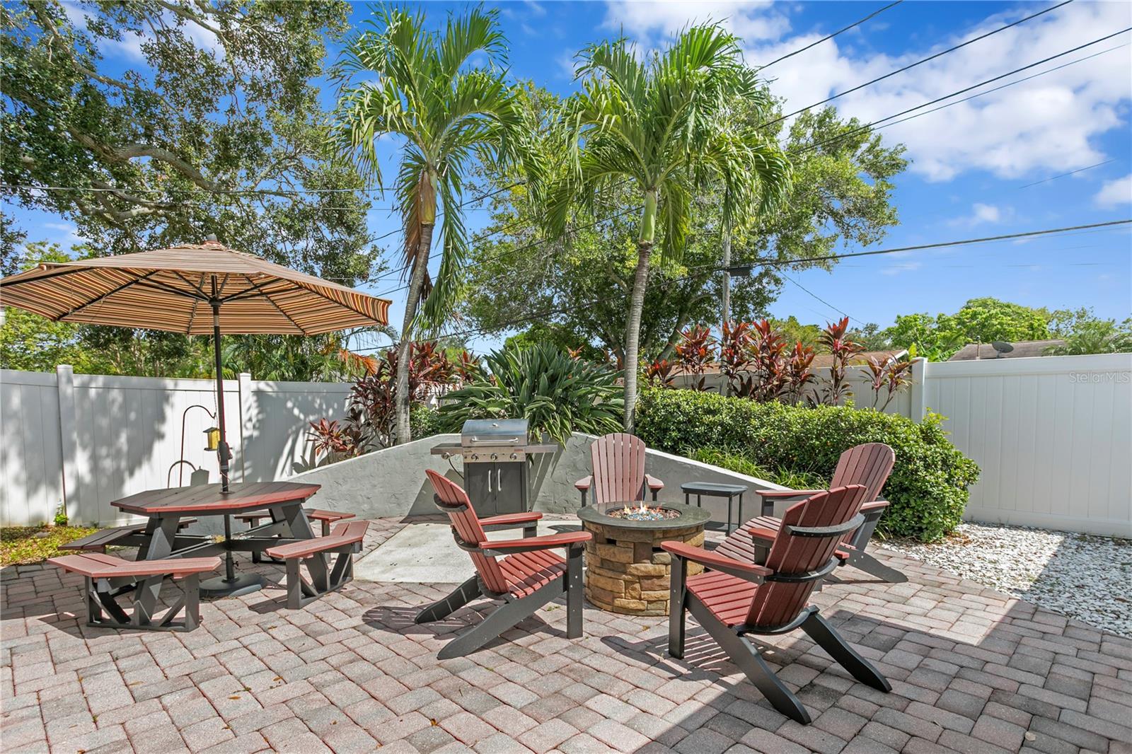 Paved outdoor seating area with firepit