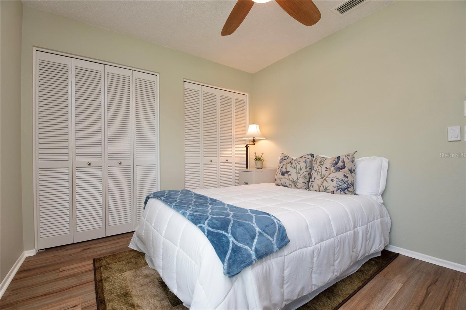 Guest bedroom with dual closets.