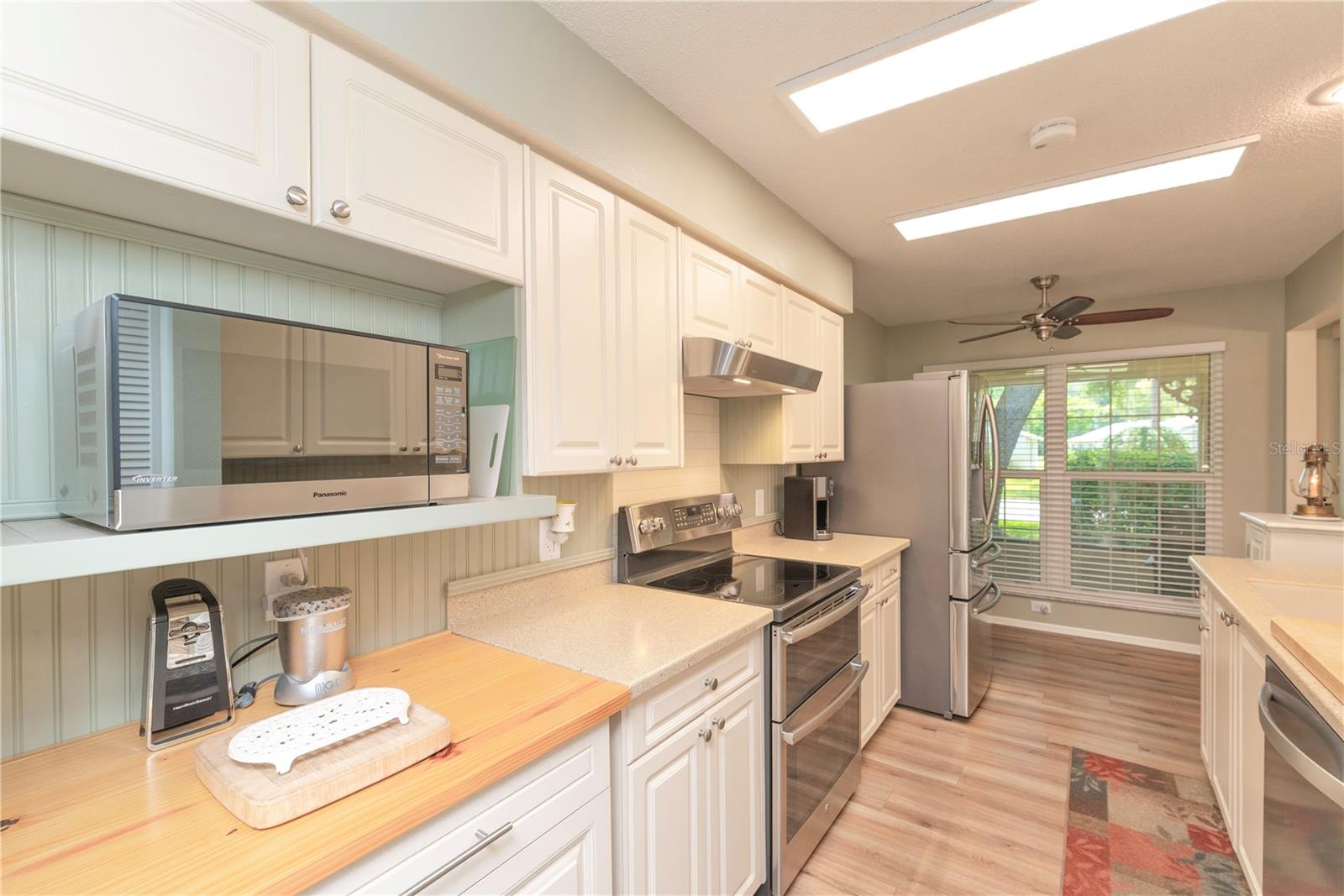 Cottage style kitchen with solid surface counters.