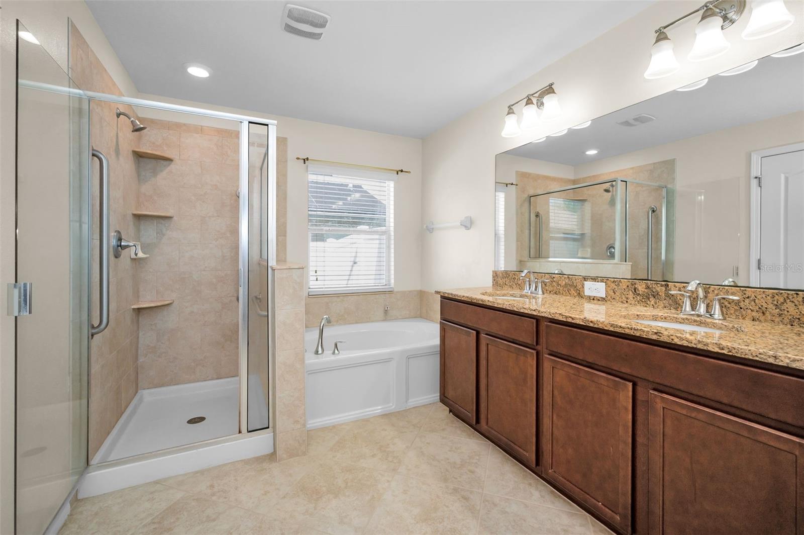Primary/master bath with separate shower, garden tub, dual sinks and granite countertops