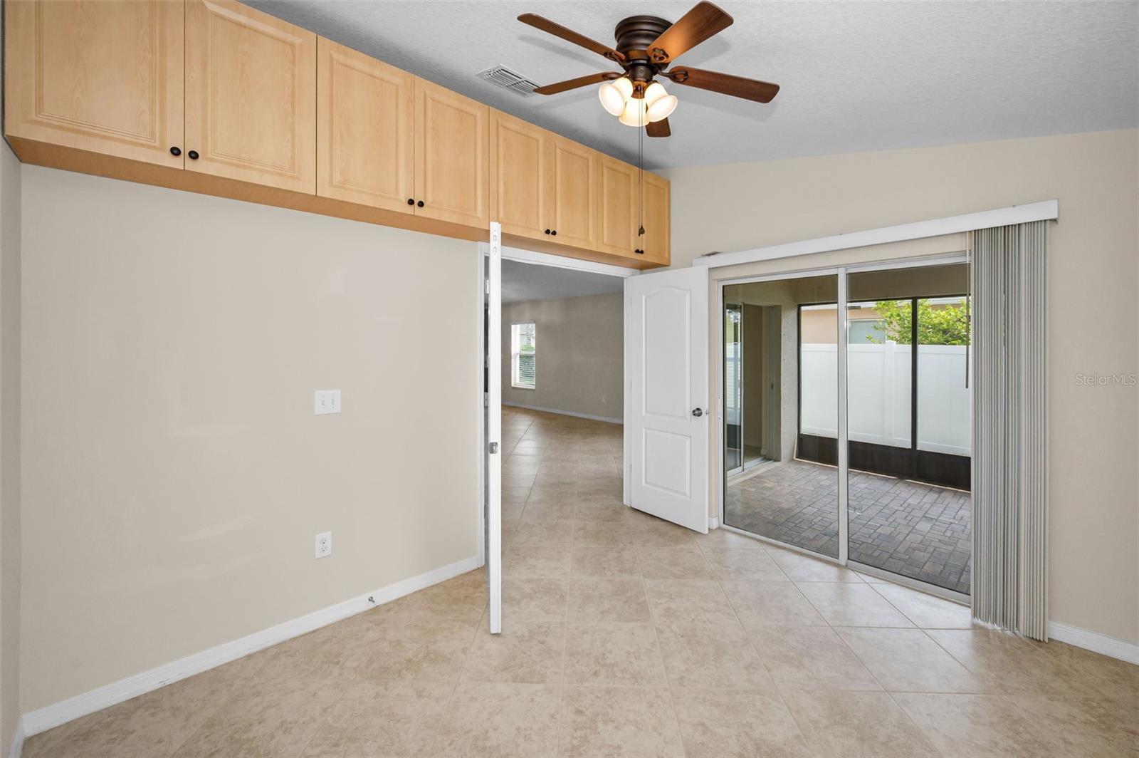 Office/study/den which has extrac custom cabinetry for extra books/storage/  Sliders out to lanai area also.