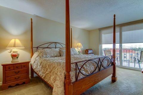 Primary Bedroom with floor to ceiling sliders leading out to balcony