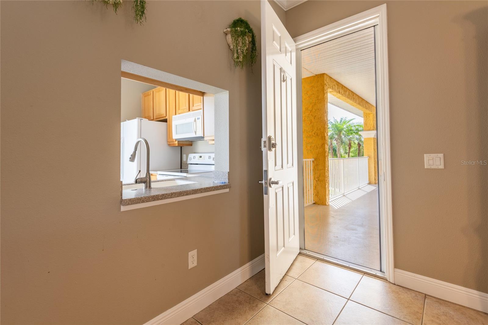 ENTER INTO THE LIVING AREA.  PASS THRU KITCHEN WINDO TO LEFT IN PICTURE