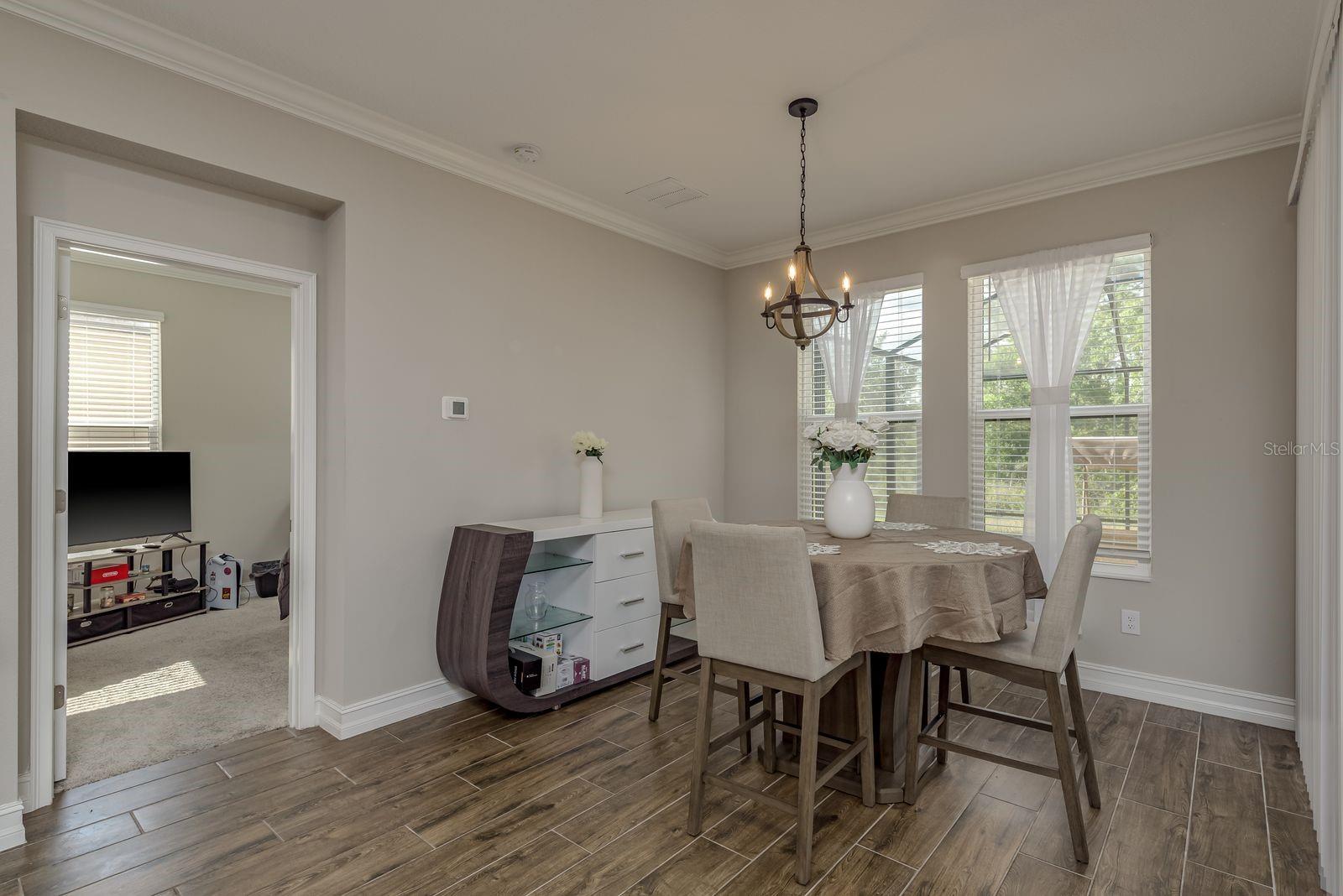 Breakfast nook with sliding glass door to covered patio and screened in lanai