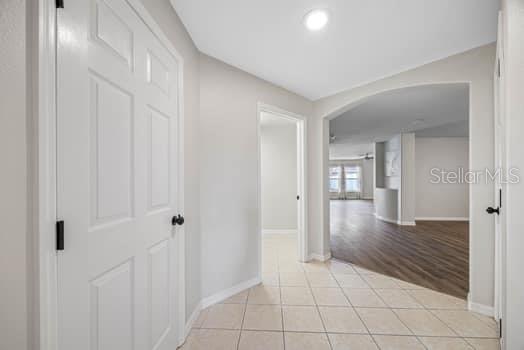 Powder room and laundry room to the left and door to the garage to the right.  Arched entry into main living area.