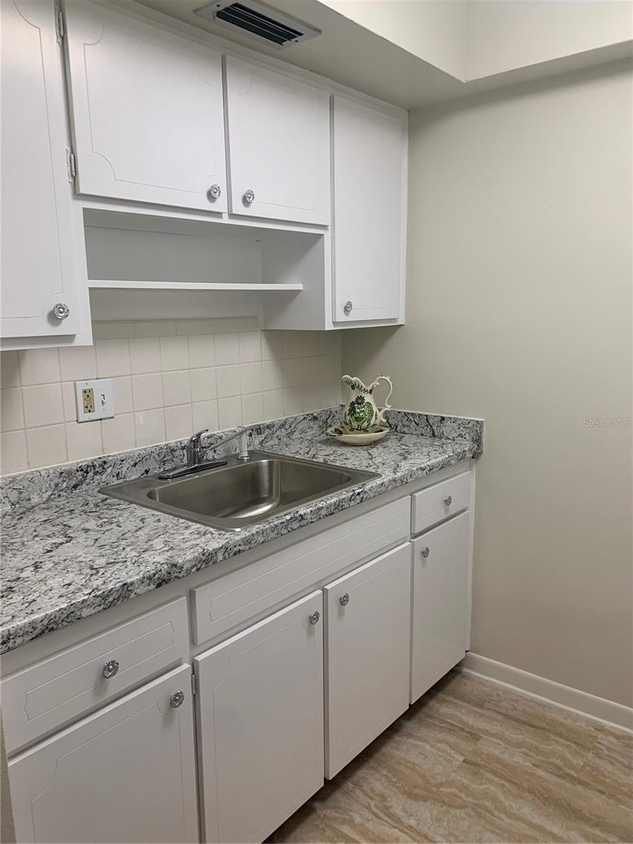 Nicely updated painted cabinets, new countertops, new sink.