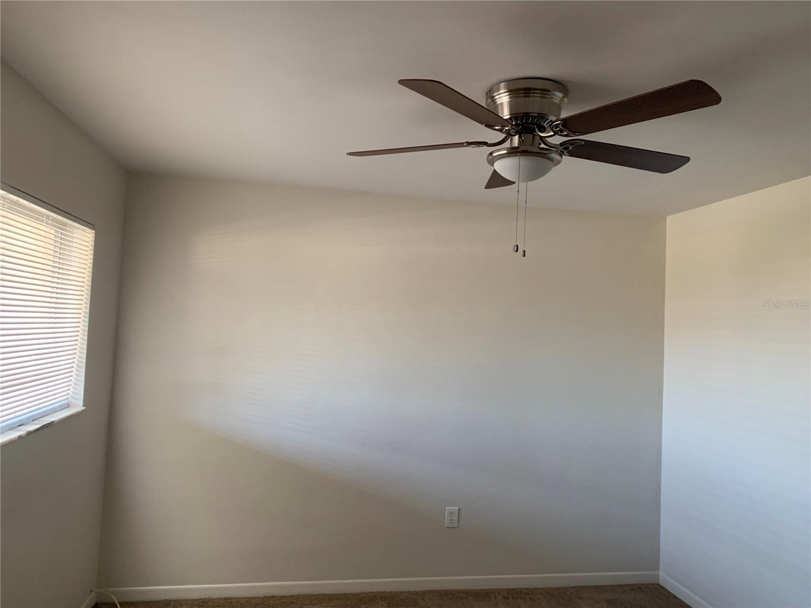 Ceiling fan in bedroom.
