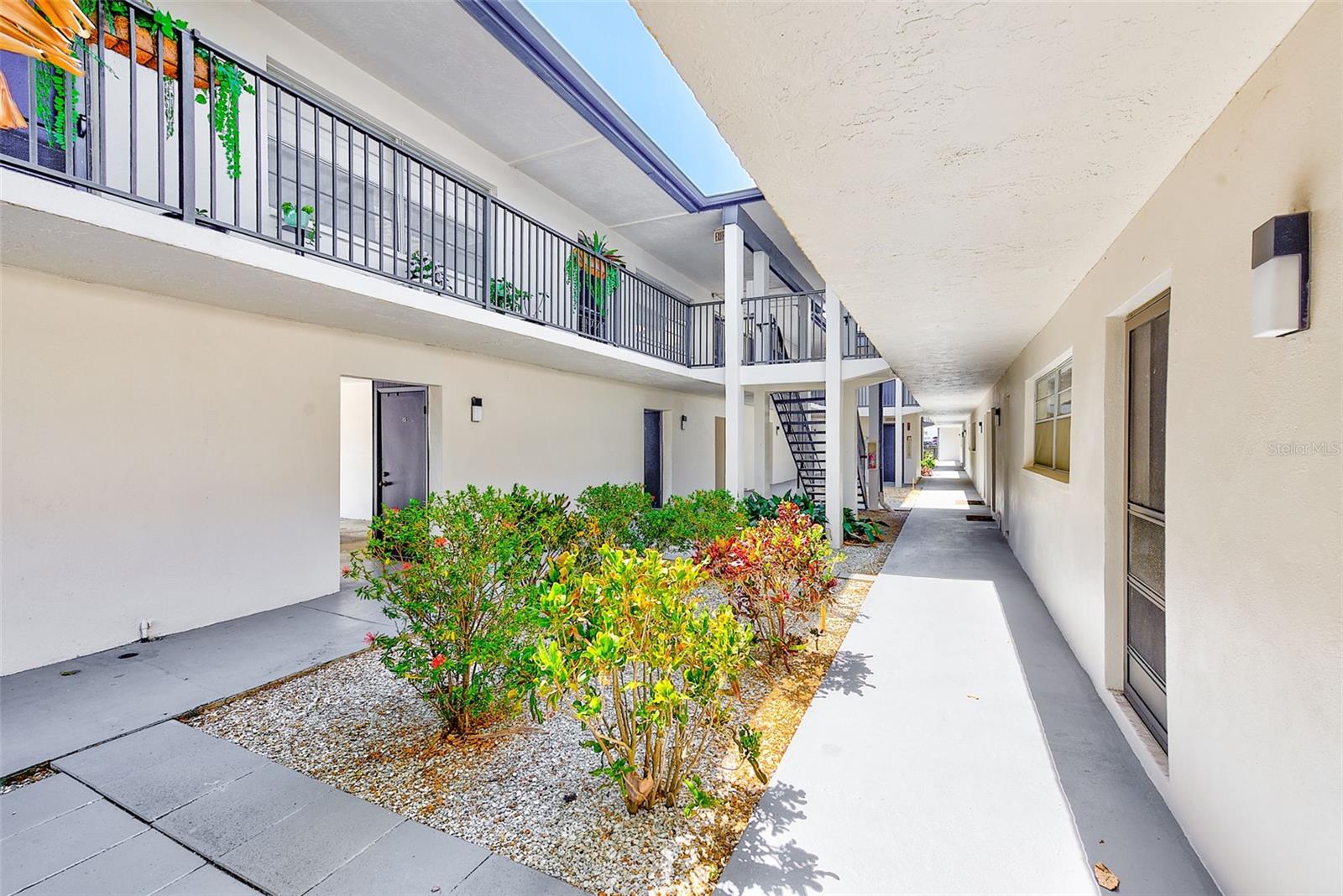 Courtyard between carport/storage and condo building
