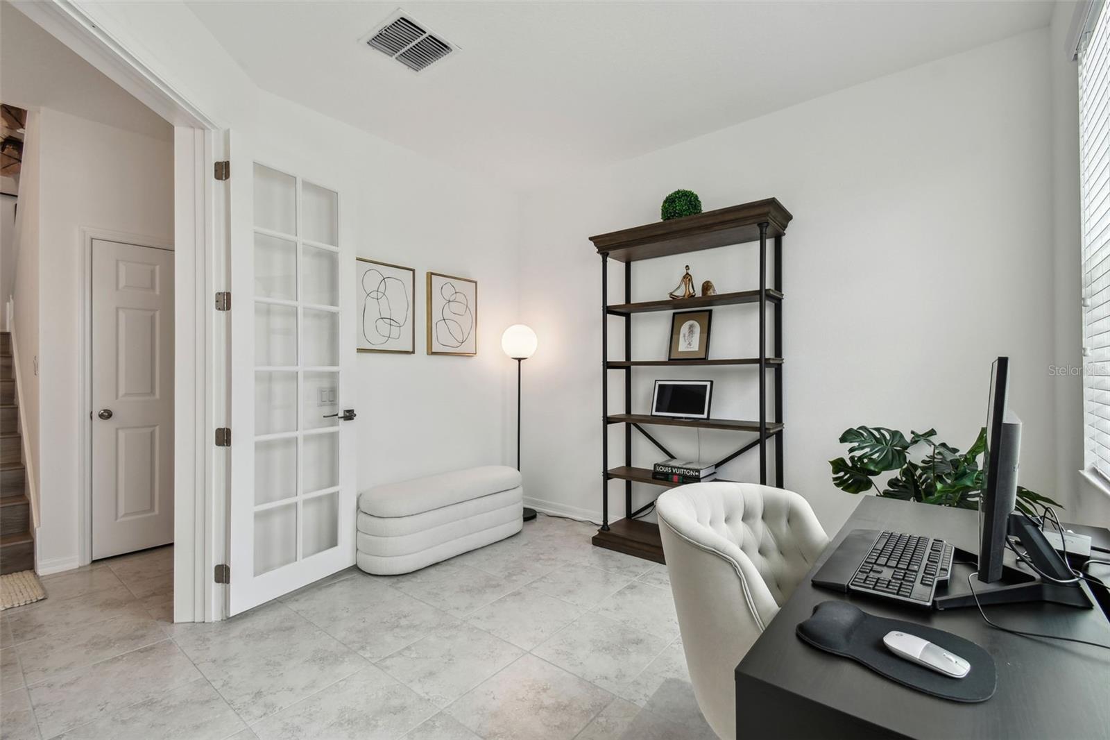This beautiful office area on the main floor overlooks the front of the home. Well sized, this space could have multiple uses, and already has french doors to close it off if needed.