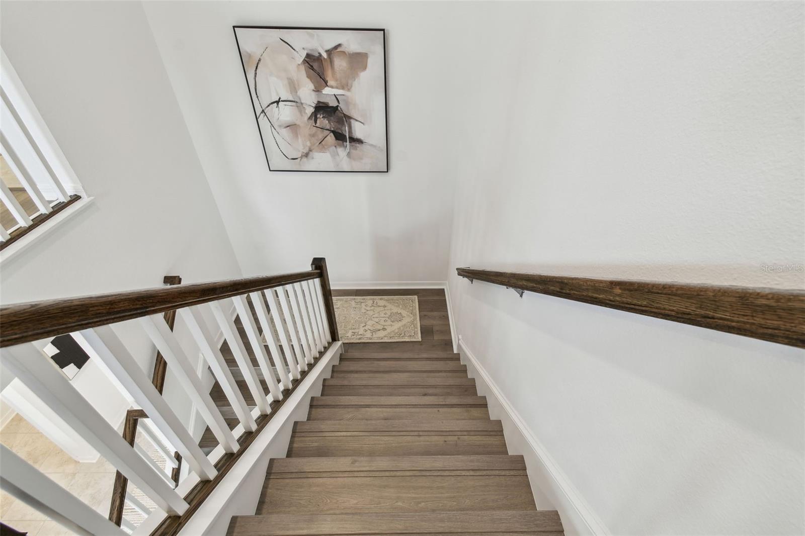Stairs lead up to the open loft and three bedroms, two baths upstairs
