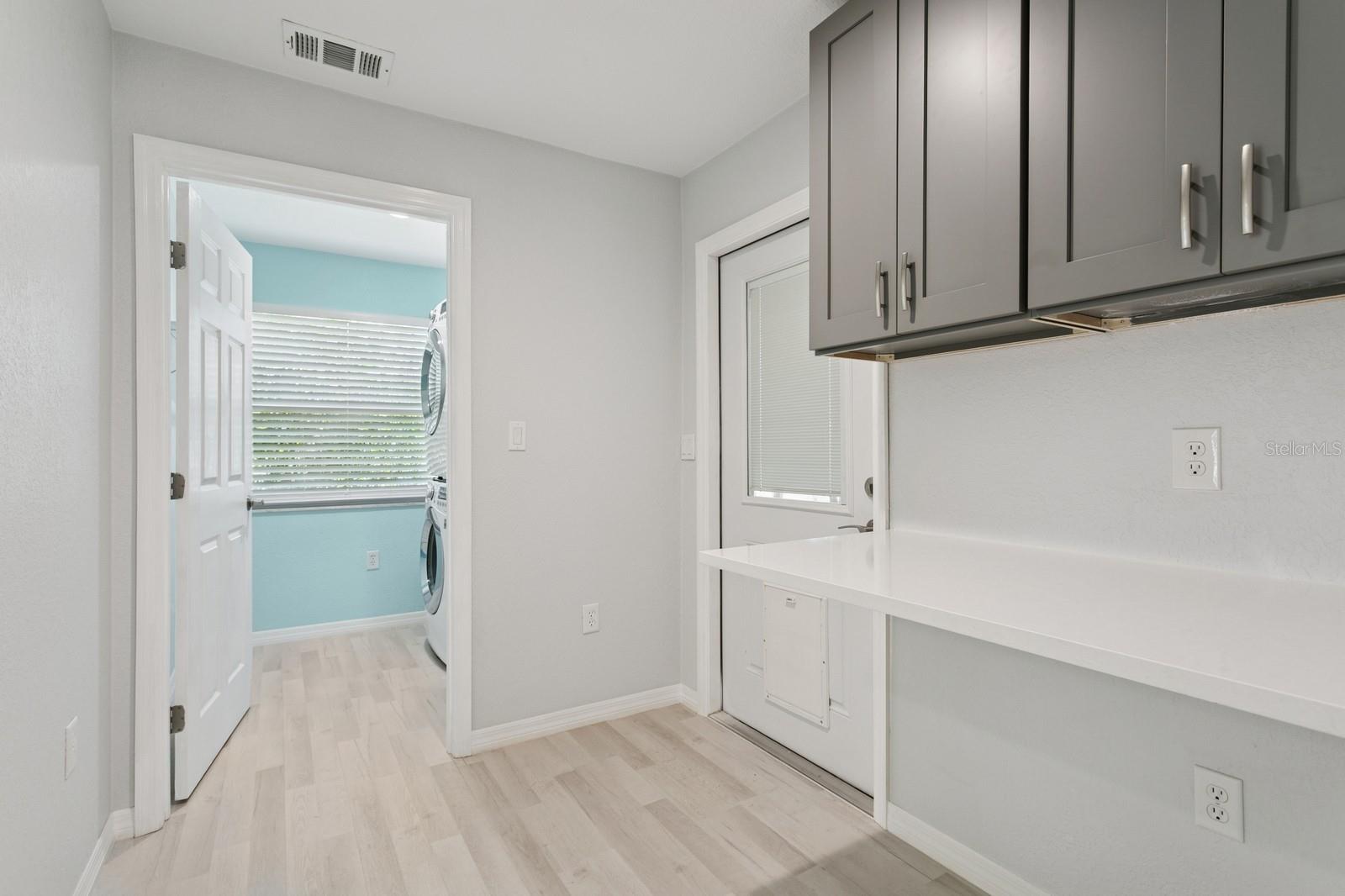 Hallway to laundry room and back door has built-in desk space