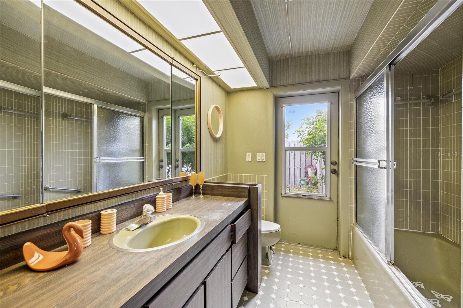 2nd full bathroom in hallway with outdoor access