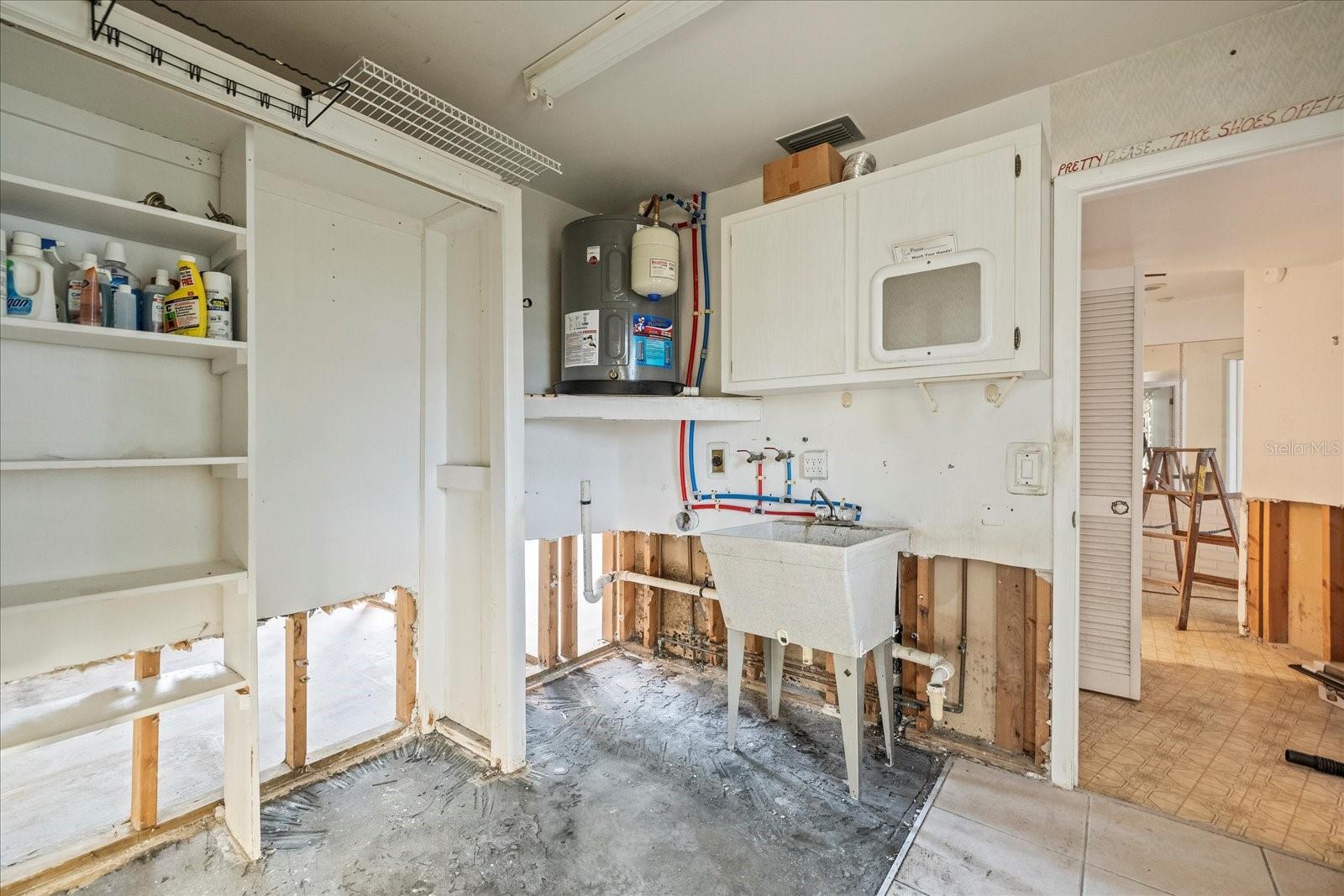 Laundry room with water heater elevated