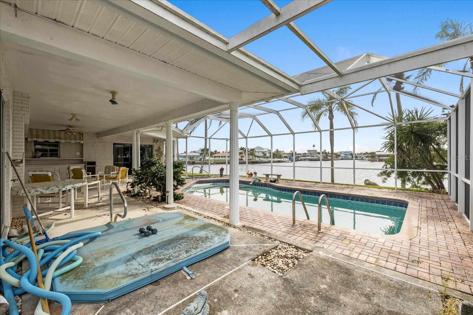covered porch,Hot tub and fully screened pool cage area