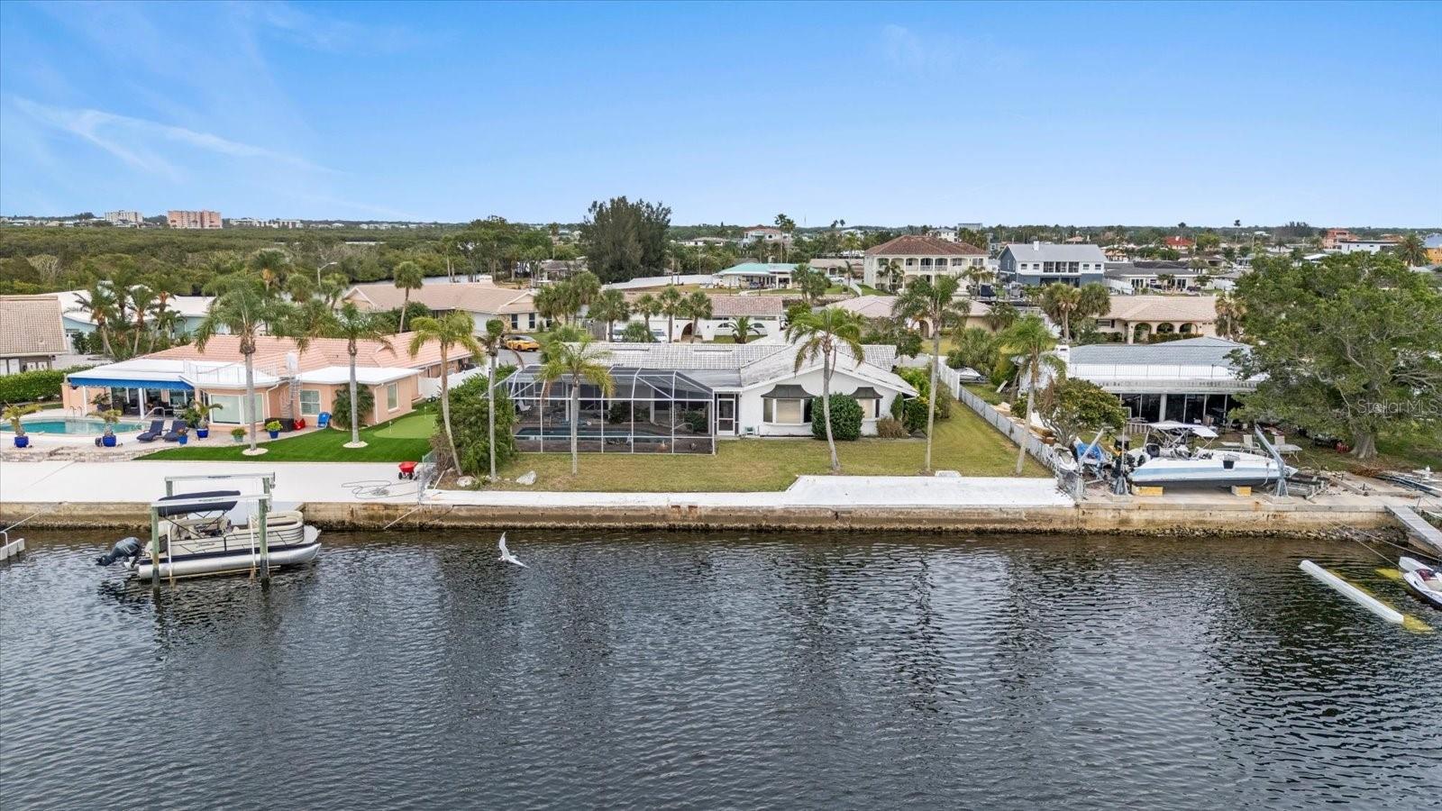 View of 100' seawall from wide backyard canal