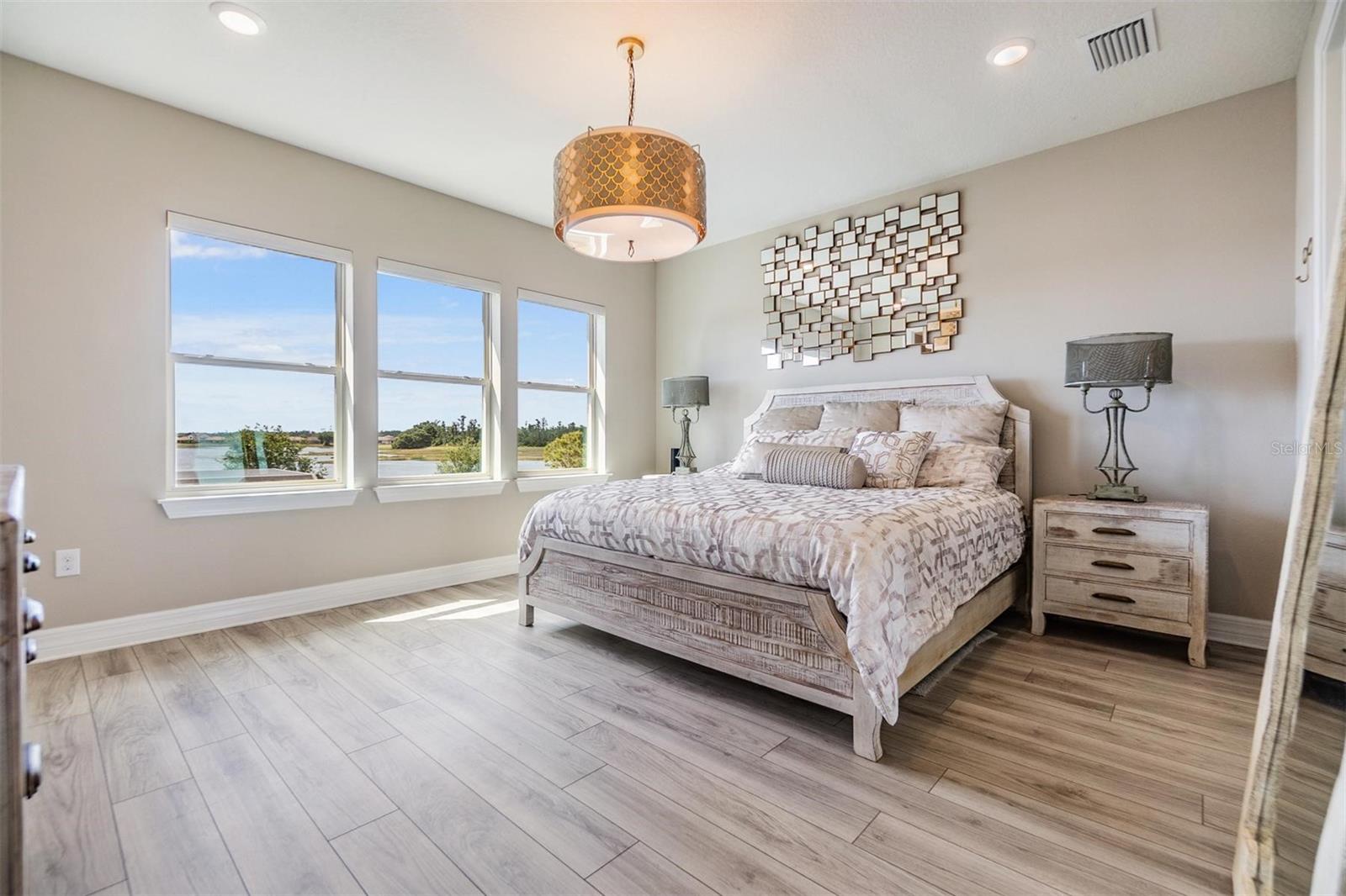 primary bedroom with views of the beautiful lake
