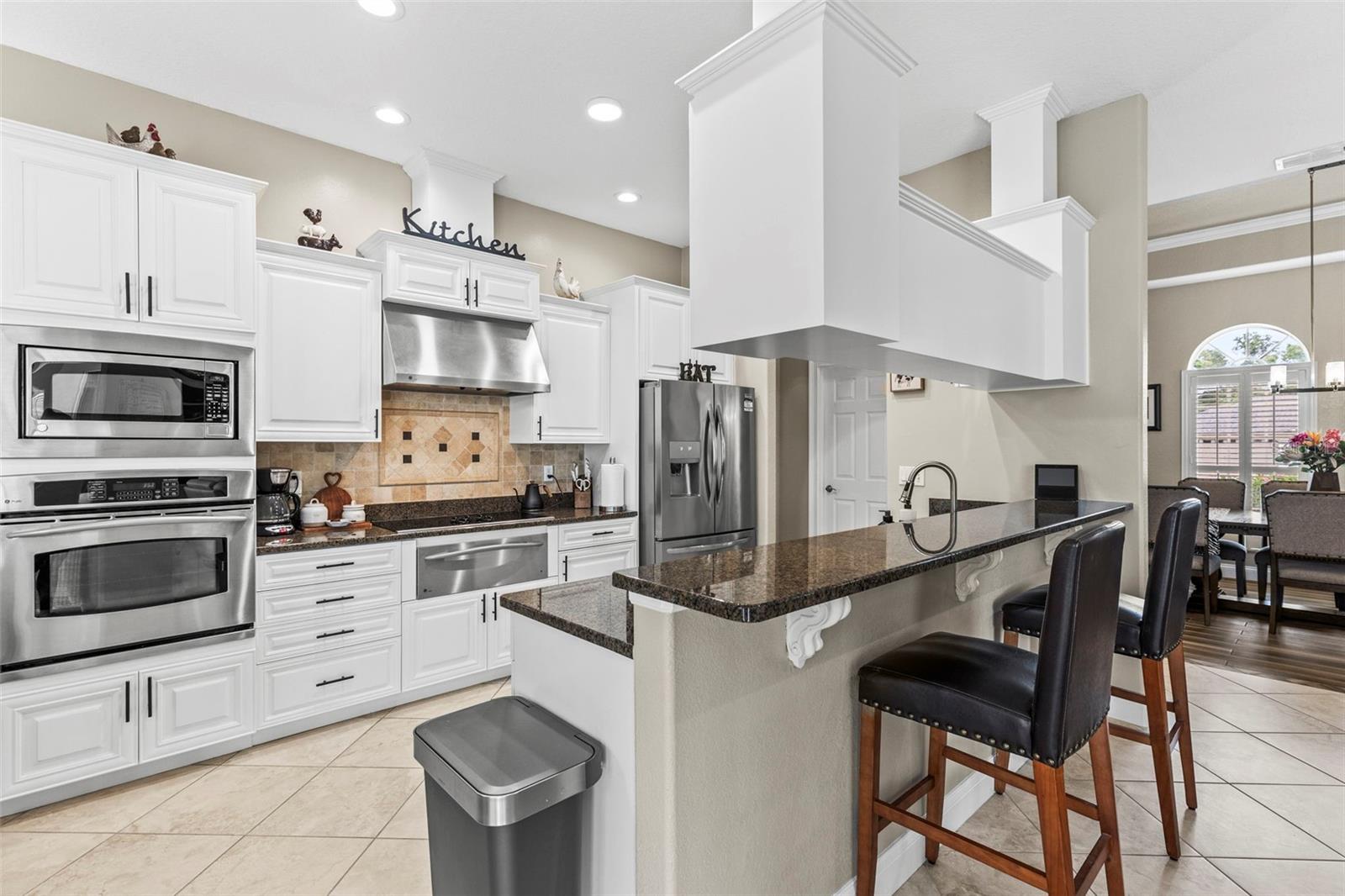 Built in stainless steel over and microwave with a warming drawer under the cook top