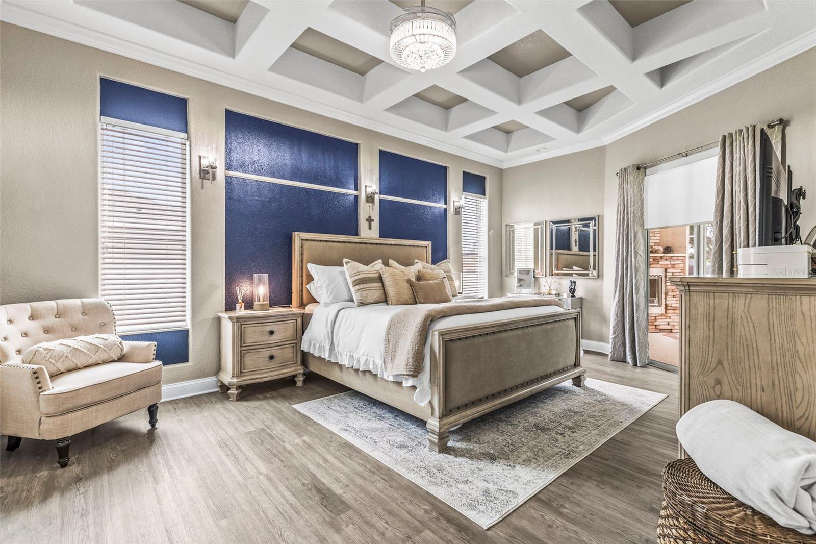 Primary bedroom with high ceilings and custom light/fan