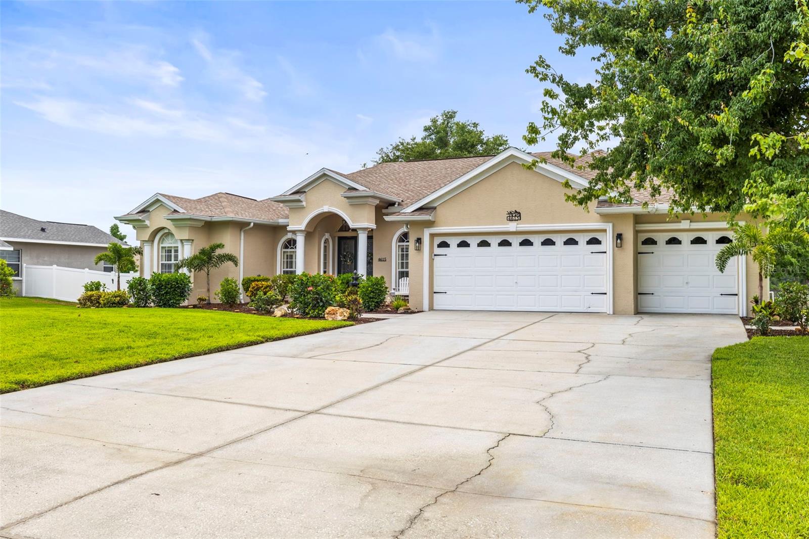 Extra wide driveway leading to the three car garage