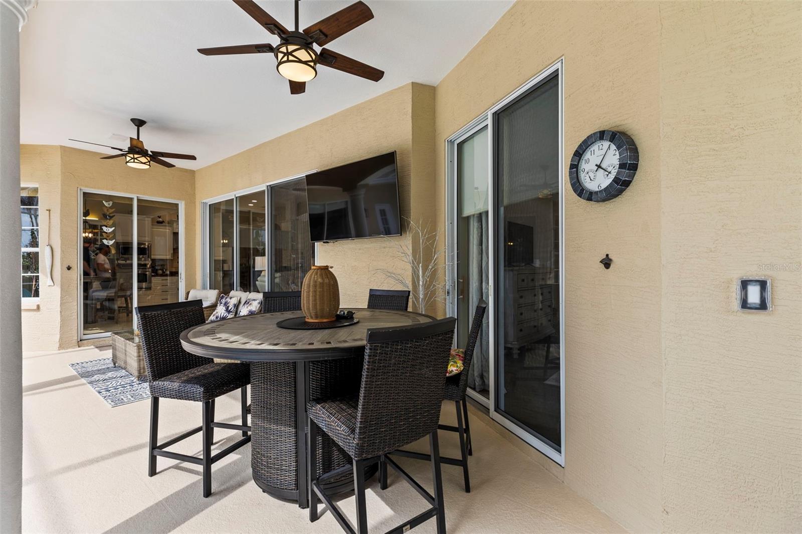 Shaded seating area with two ceiling fans/lights