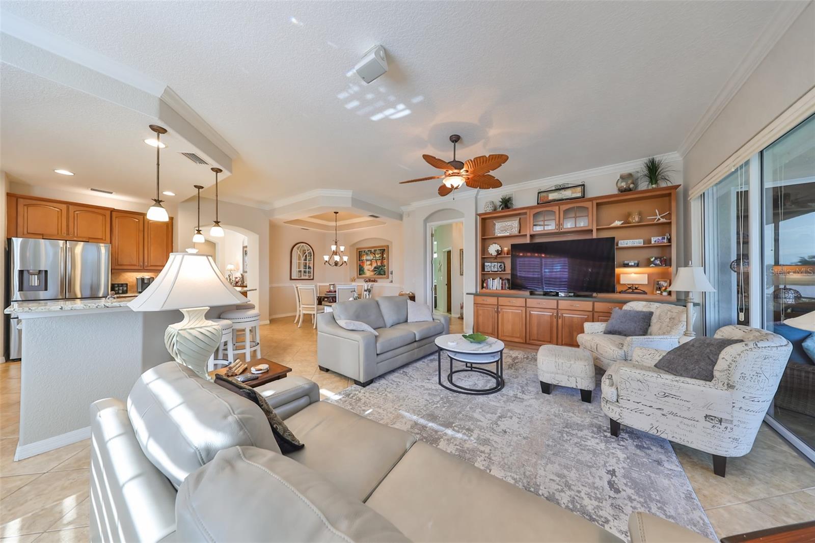 The open floor plan is a welcome amenity in this unit.  Notice the crown molding, pendant lighting and speaker system in the ceiling.