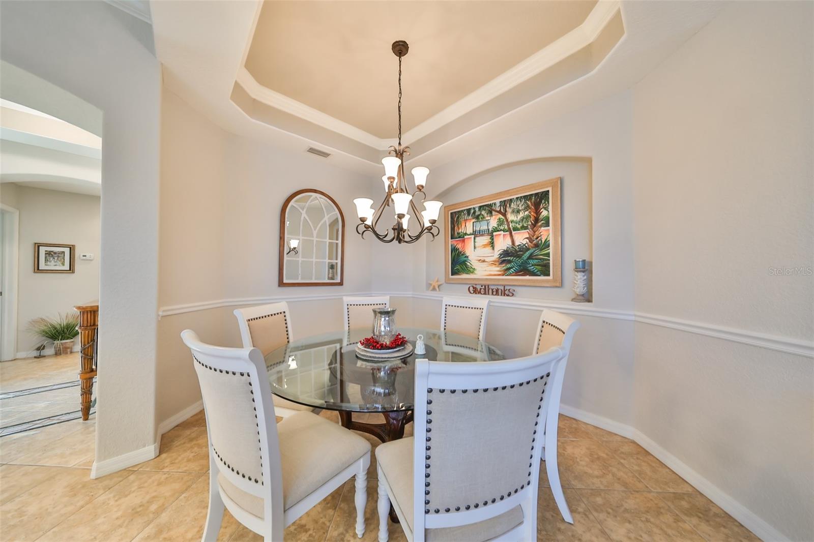 The dining area is perfect for an intimate setting.  The trey ceiling and crown molding offer an elegant touch to the space.