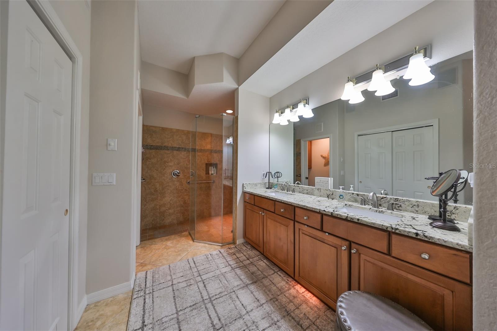 The master bath is fully updated with granite counters, glass shower and all wood cabinetry.