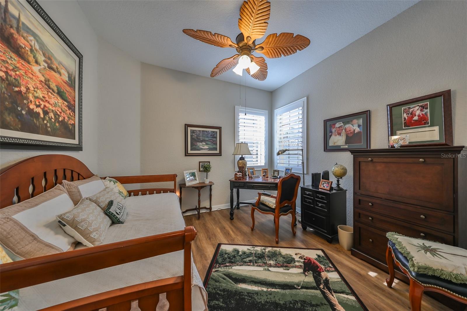 Bedroom #2 has luxury vinyl plank flooring, custom fan and plantation shutters.
