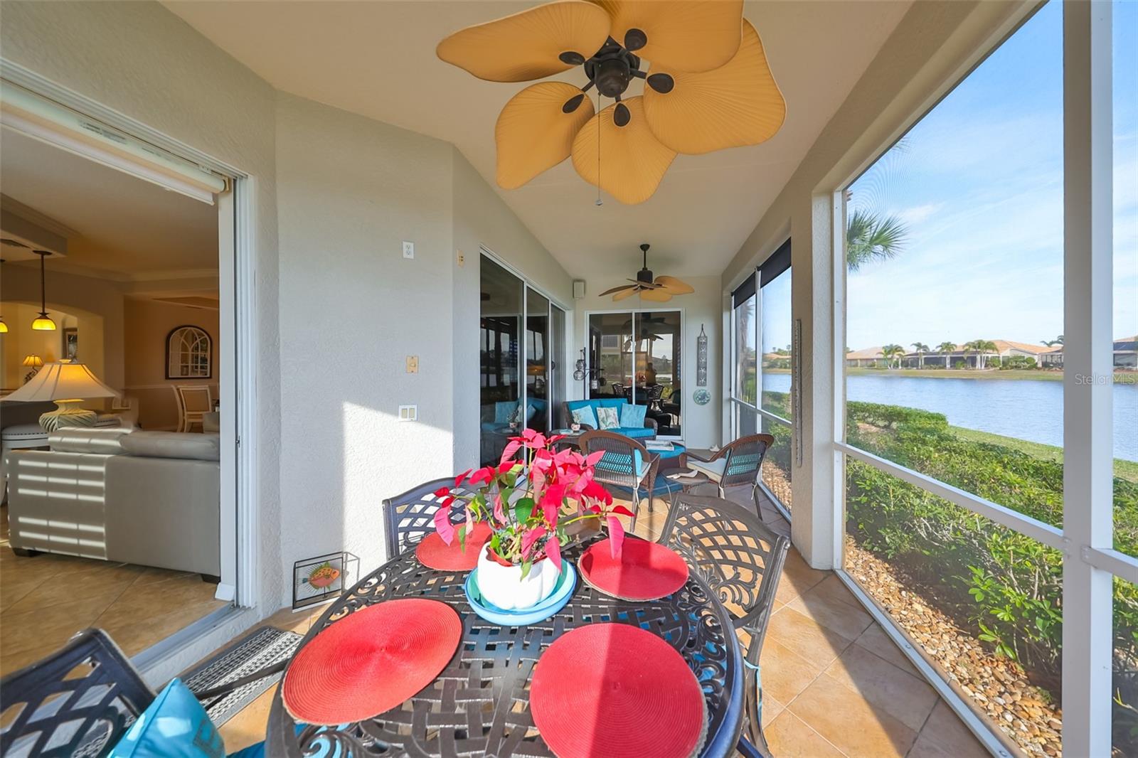 Beautiful tile flooring, tropical ceiling fans, shade screens and a manicured lawn for enjoyment.