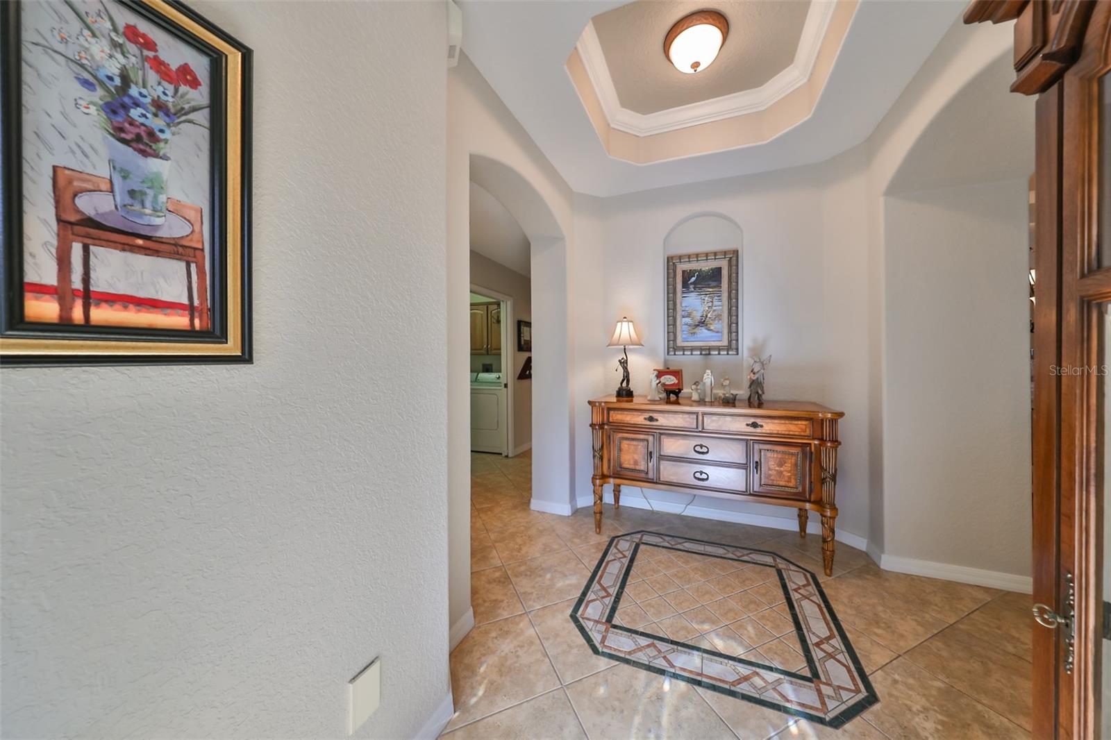 Notice the trey ceiling, architectural niche and custom medallion in the front foyer.