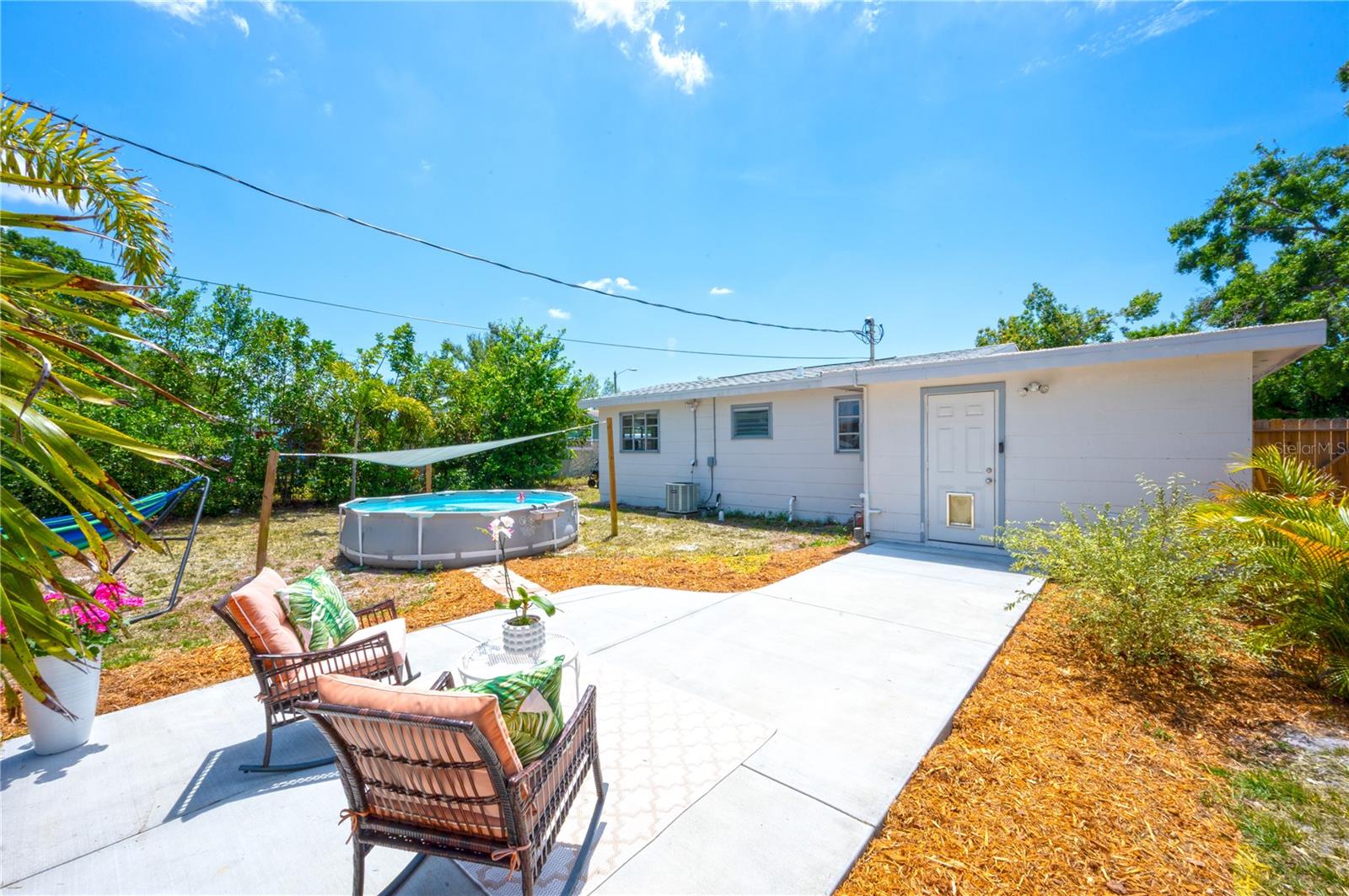 Spacious backyard with patio and pool with sand pump