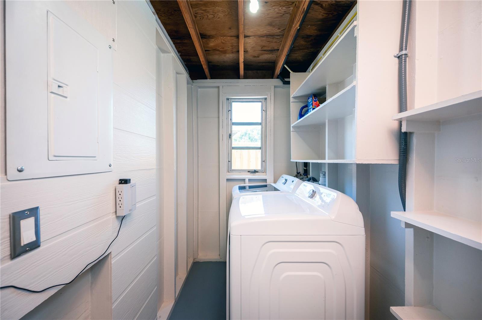 Inside laundry with newer full size washer and dryer