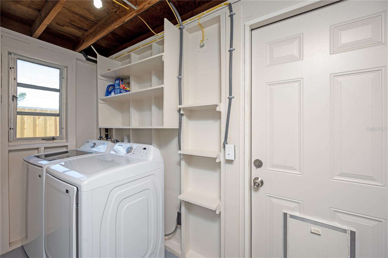 Inside laundry with newer full size washer and dryer