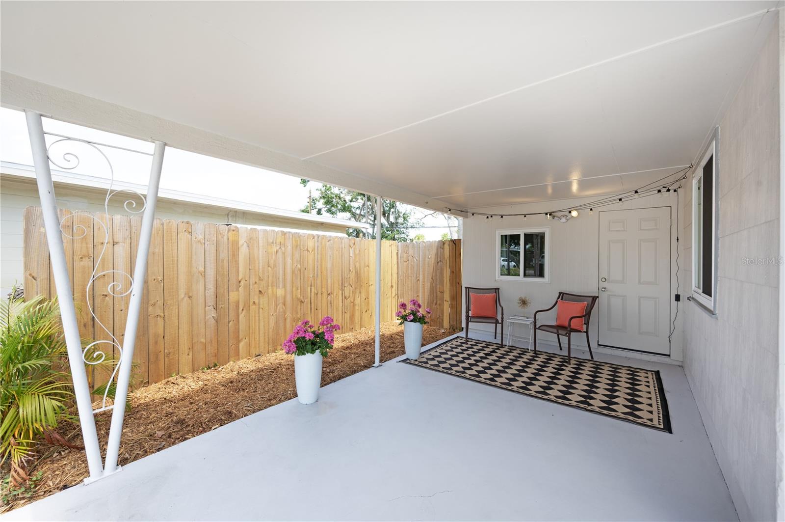 Covered carport area perfect as a patio or for parking