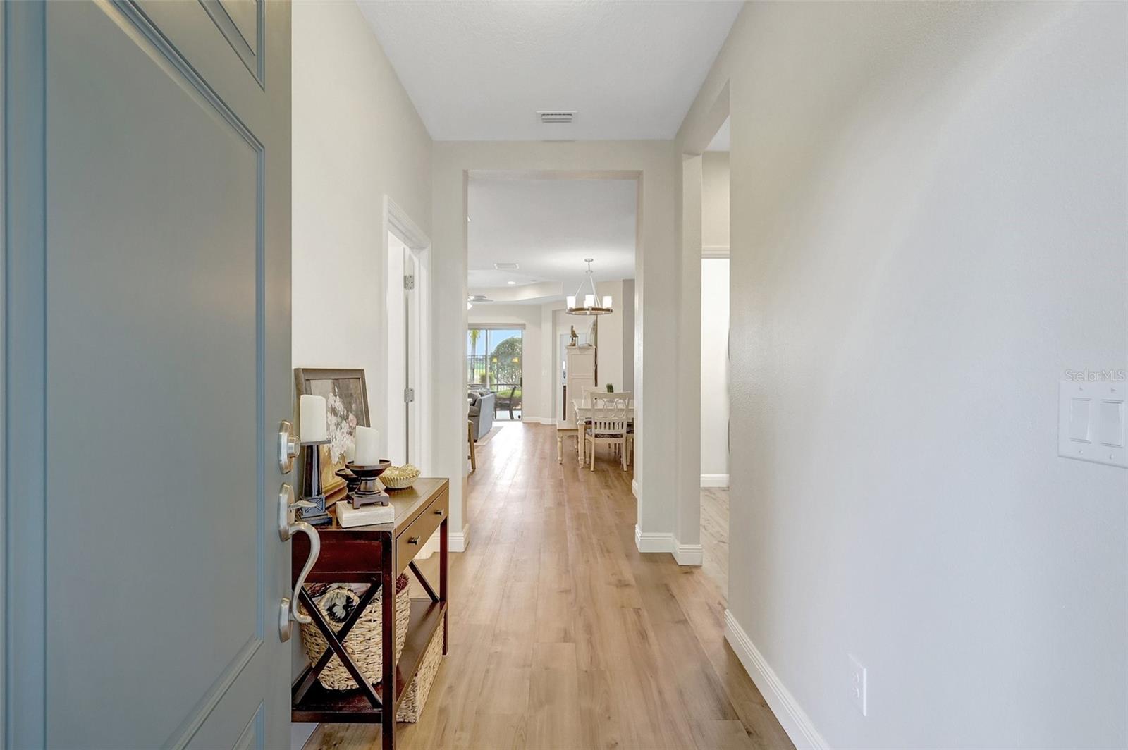 View of Foyer Entryway with 2nd Bedroom, Laundry Room and Main Bath on right -  Den/Office on left