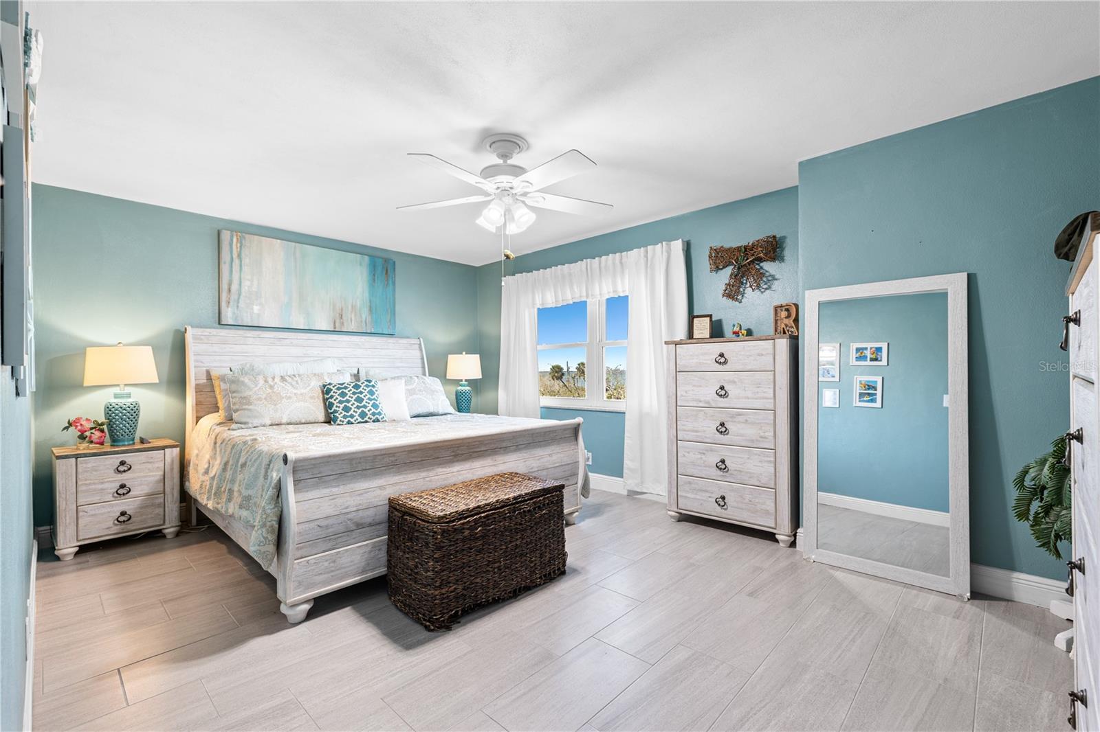 Step into the primary bedroom where the bustle of the day quickly melts away