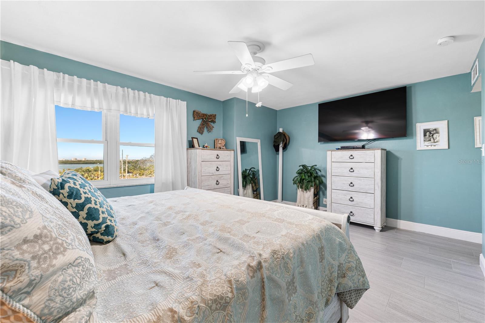 This primary retreat currently accommodates a King sized bed with plenty of room to spread out, move around and even add a desk if needed.