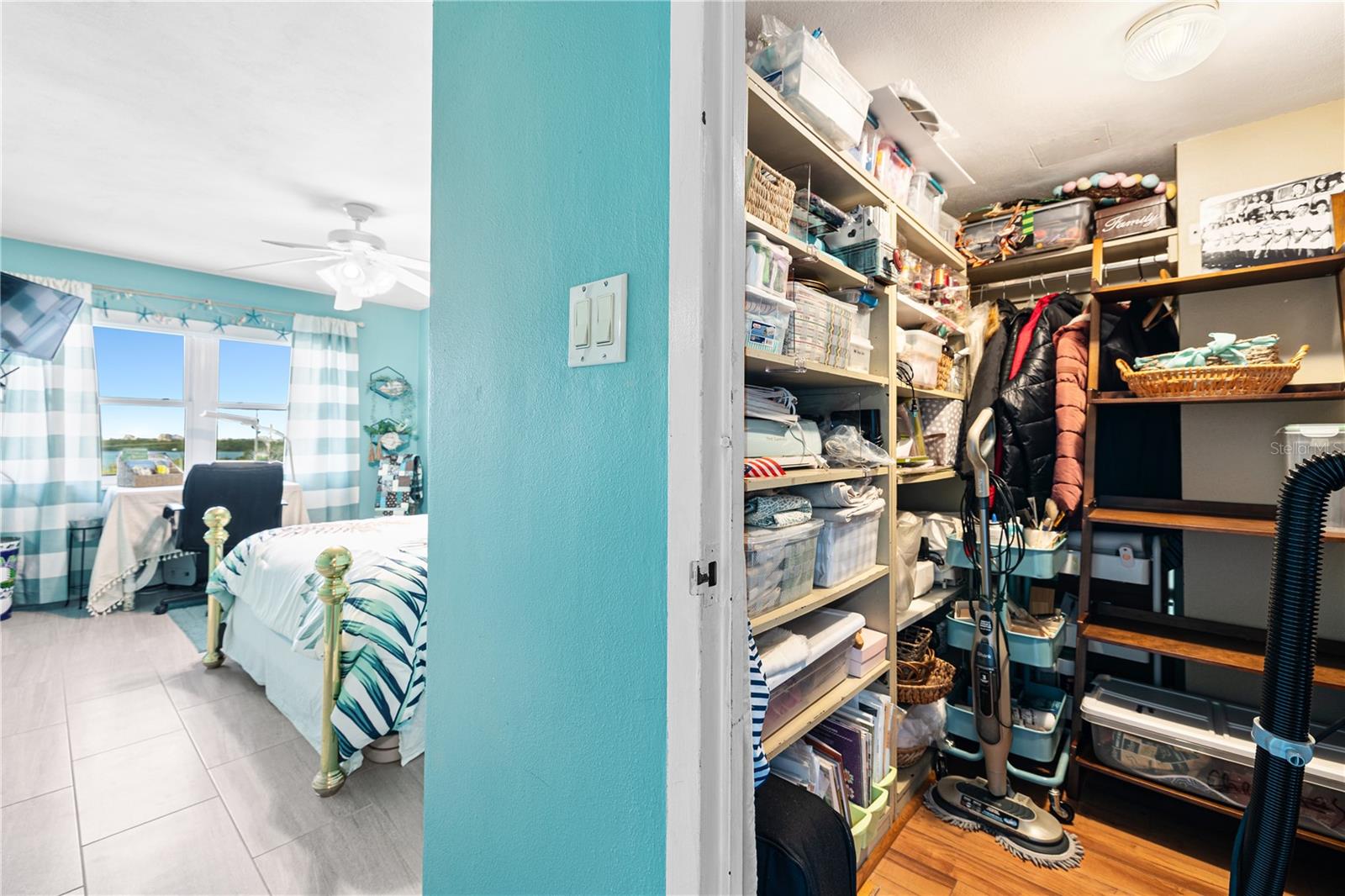 Large walk-in closet offers plenty of space for clothes, storage or crafts.