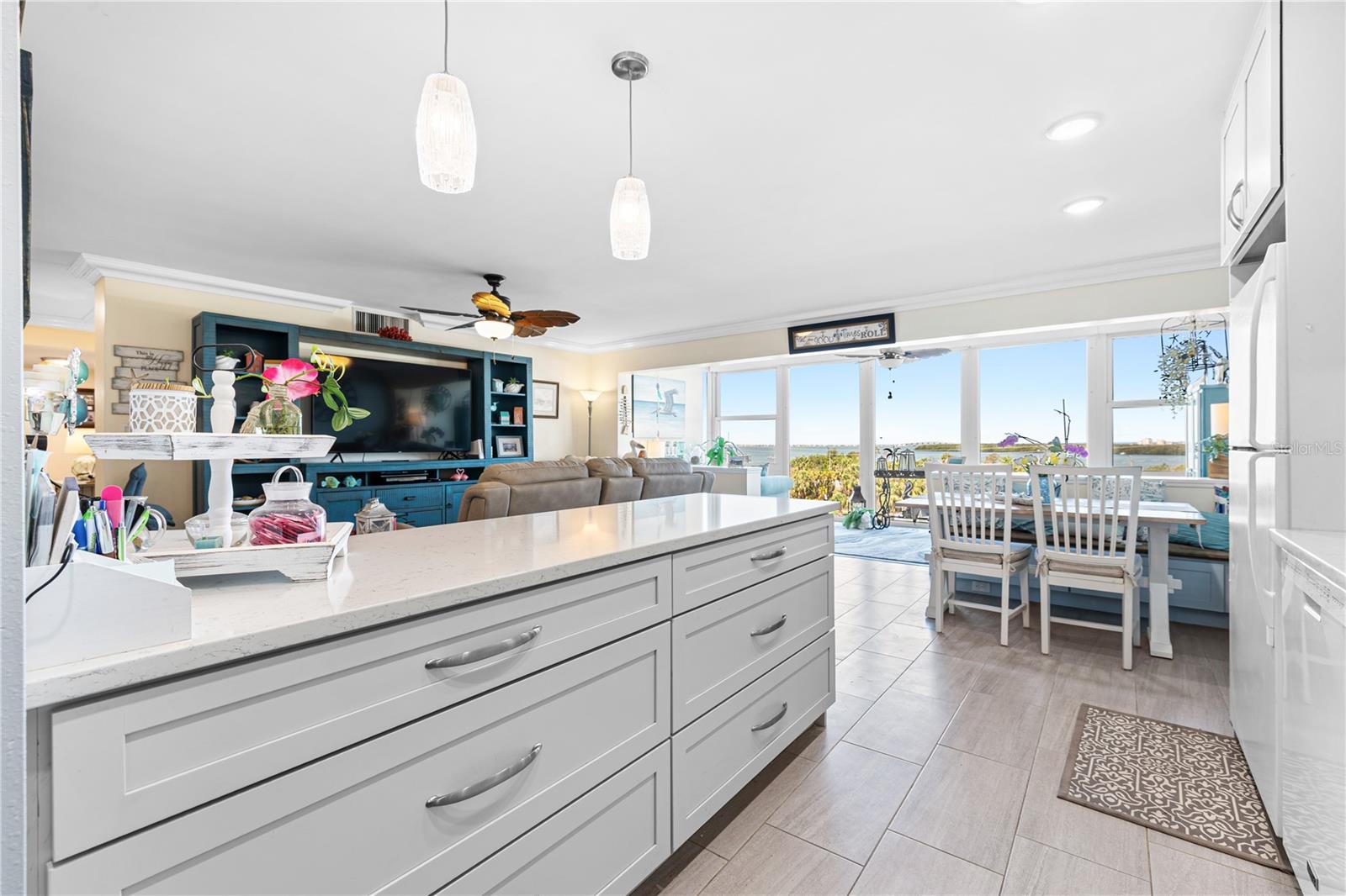 Large kitchen island could accommodate several stools, with beatiful pendant lighting.