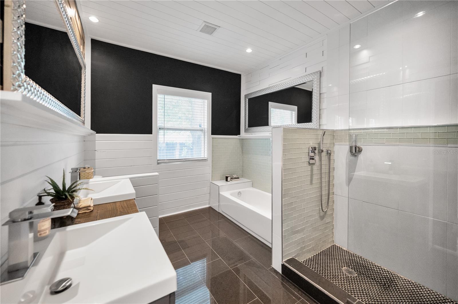 Stunning en-suite bath with custom glass shower enclosure and tub