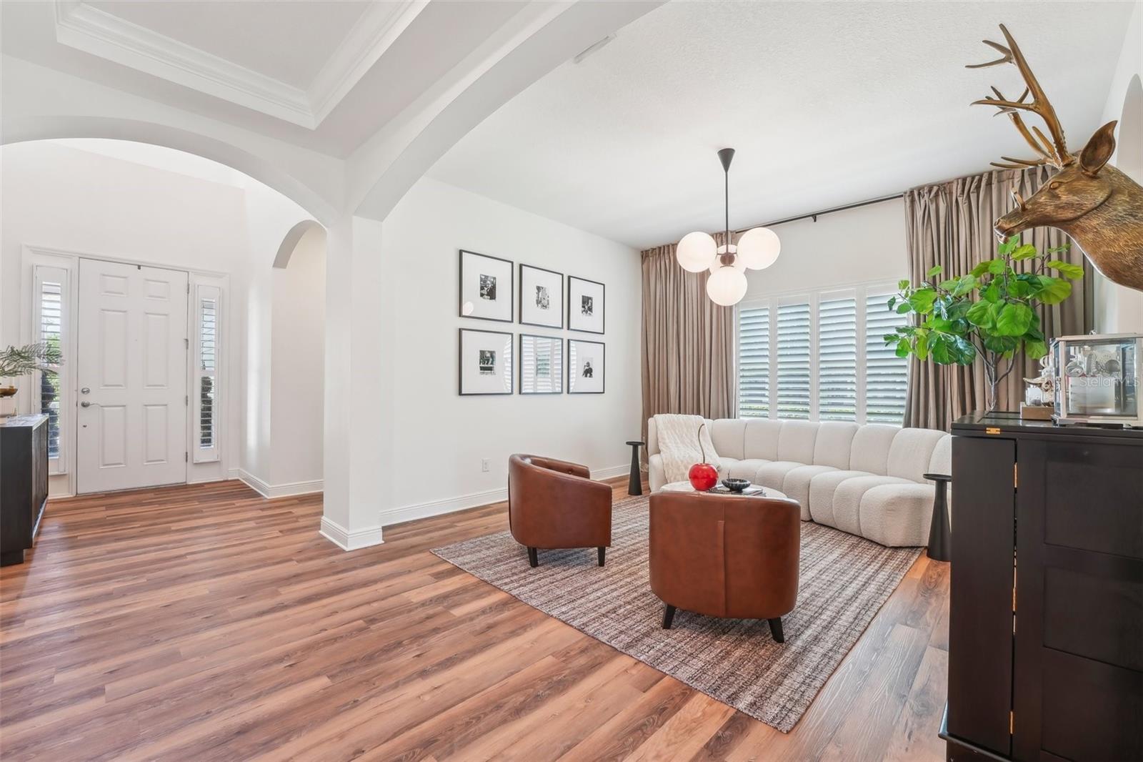INVITING FOYER LEADS TO A GENEROUSLY SIZED DINING ROOM CURRENTLY USED AS ADDITIONAL GATHERING SPACE