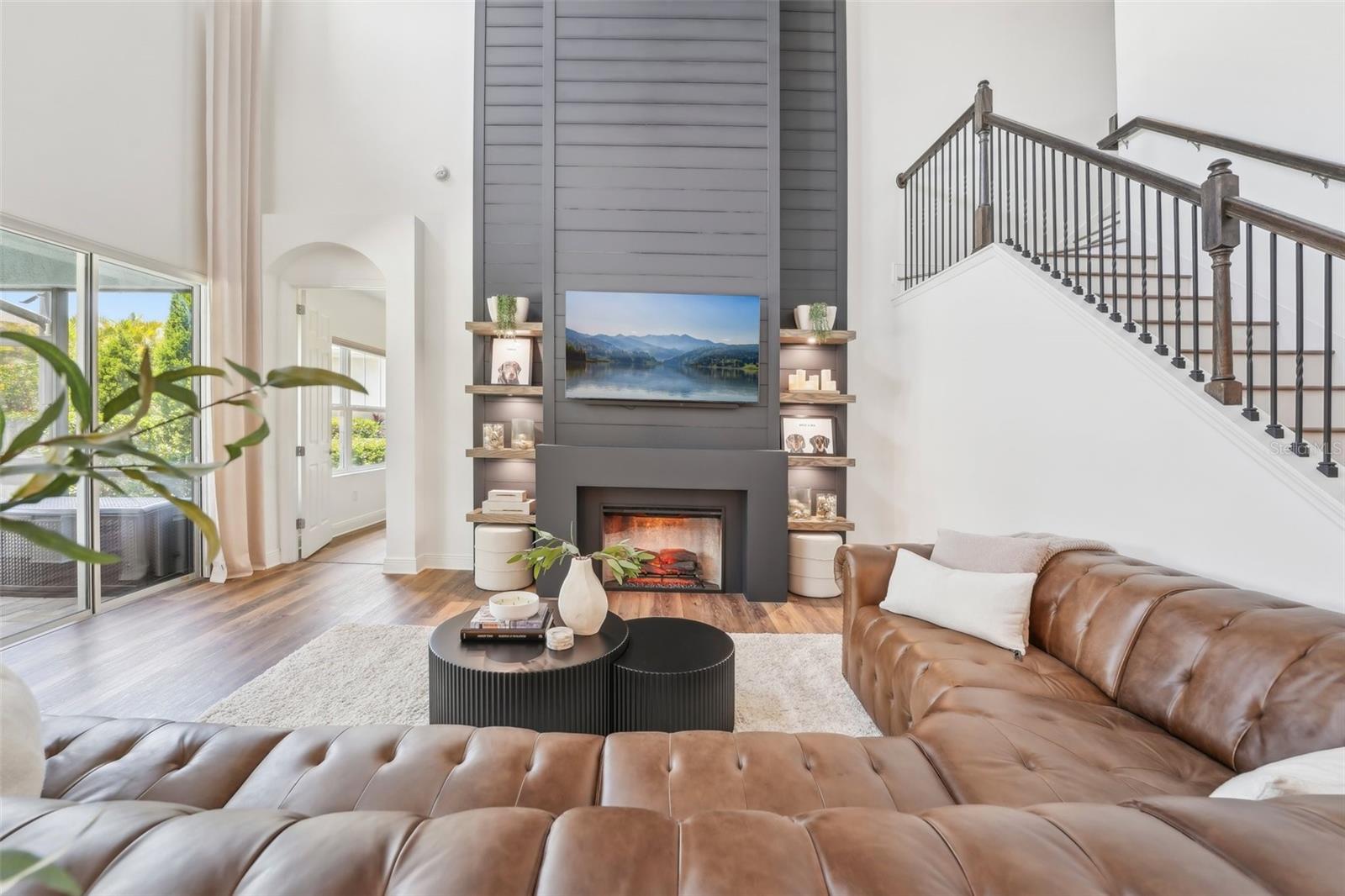 FLOOR TO CEILING CUSTOM FIREPLACE AND BUILT-IN SHELVING ADDS TO THE ELEGANCE OF YOUR NEW HOME!