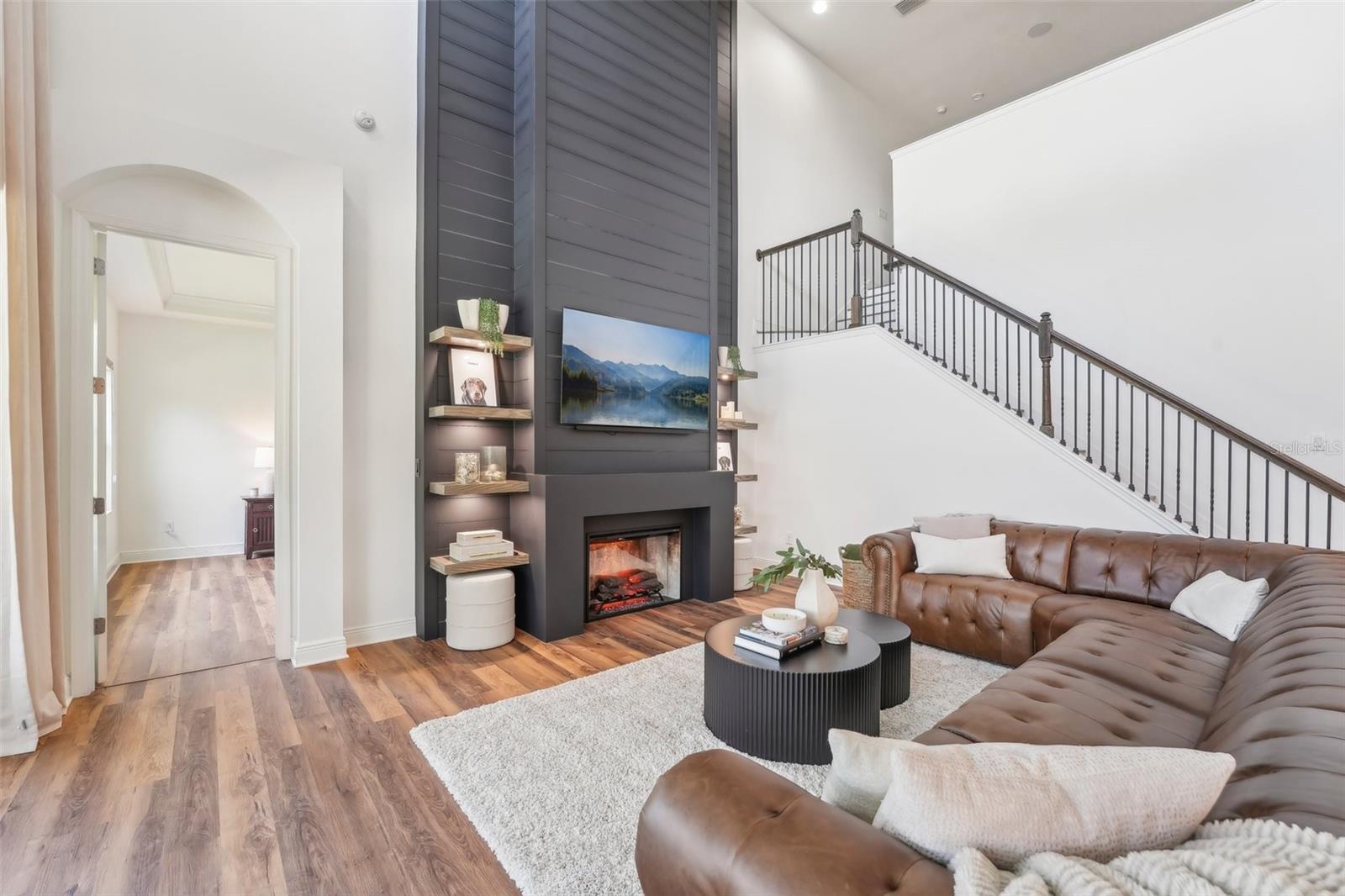 FLOOR TO CEILING CUSTOM FIREPLACE AND BUILT-IN SHELVING ADDS TO THE ELEGANCE OF YOUR NEW HOME!