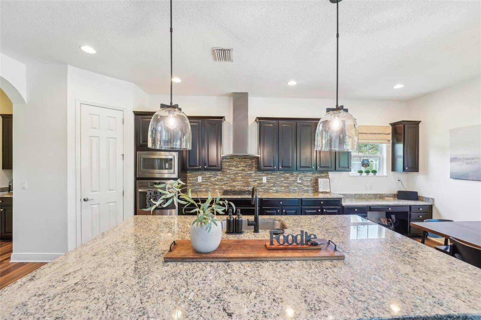 LARGE KITCHEN ISLAND PROVIDES ADDITIONAL SPACE FOR SERVING OR PREPARING YOUR FAVORITE MEALS!