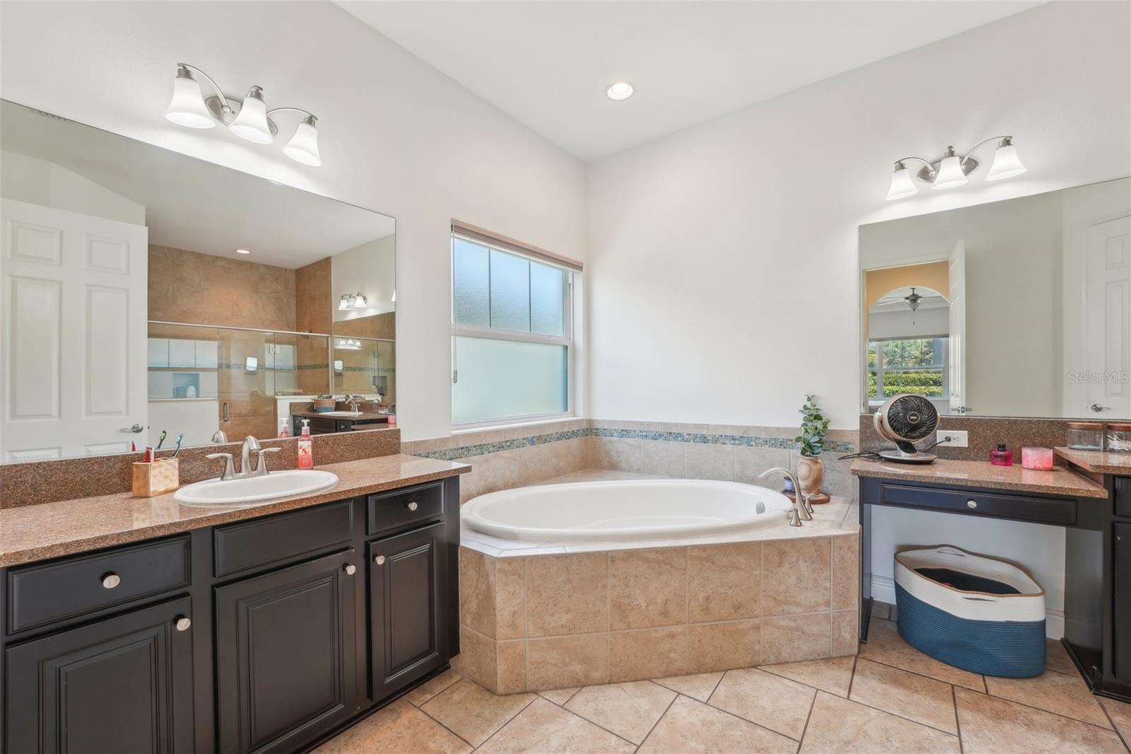 LUXURIOUS PRIMARY EN-SUITE HAS GARDEN TUB AND STEP IN SHOWER. DUAL COUNTER TOPS AND SINKS THAT PROVIDE SPACE FOR BOTH OF YOU!