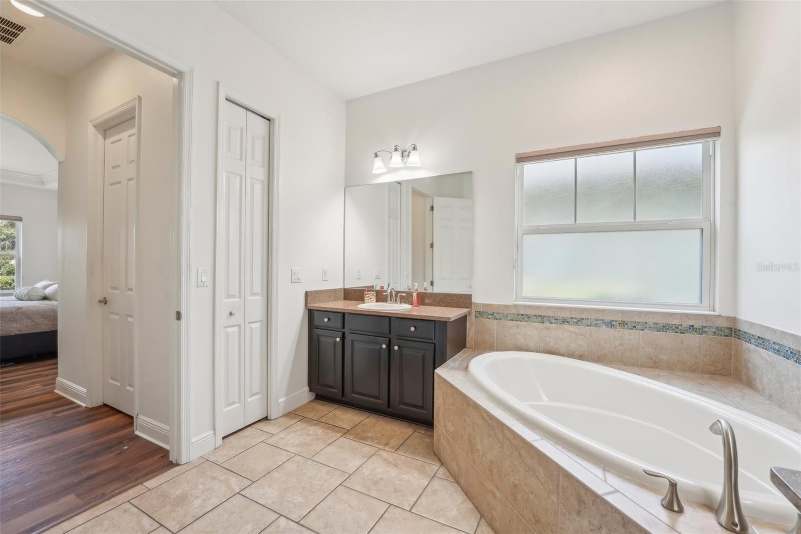 LUXURIOUS PRIMARY EN-SUITE HAS GARDEN TUB AND STEP IN SHOWER. DUAL COUNTER TOPS AND SINKS THAT PROVIDE SPACE FOR BOTH OF YOU!
