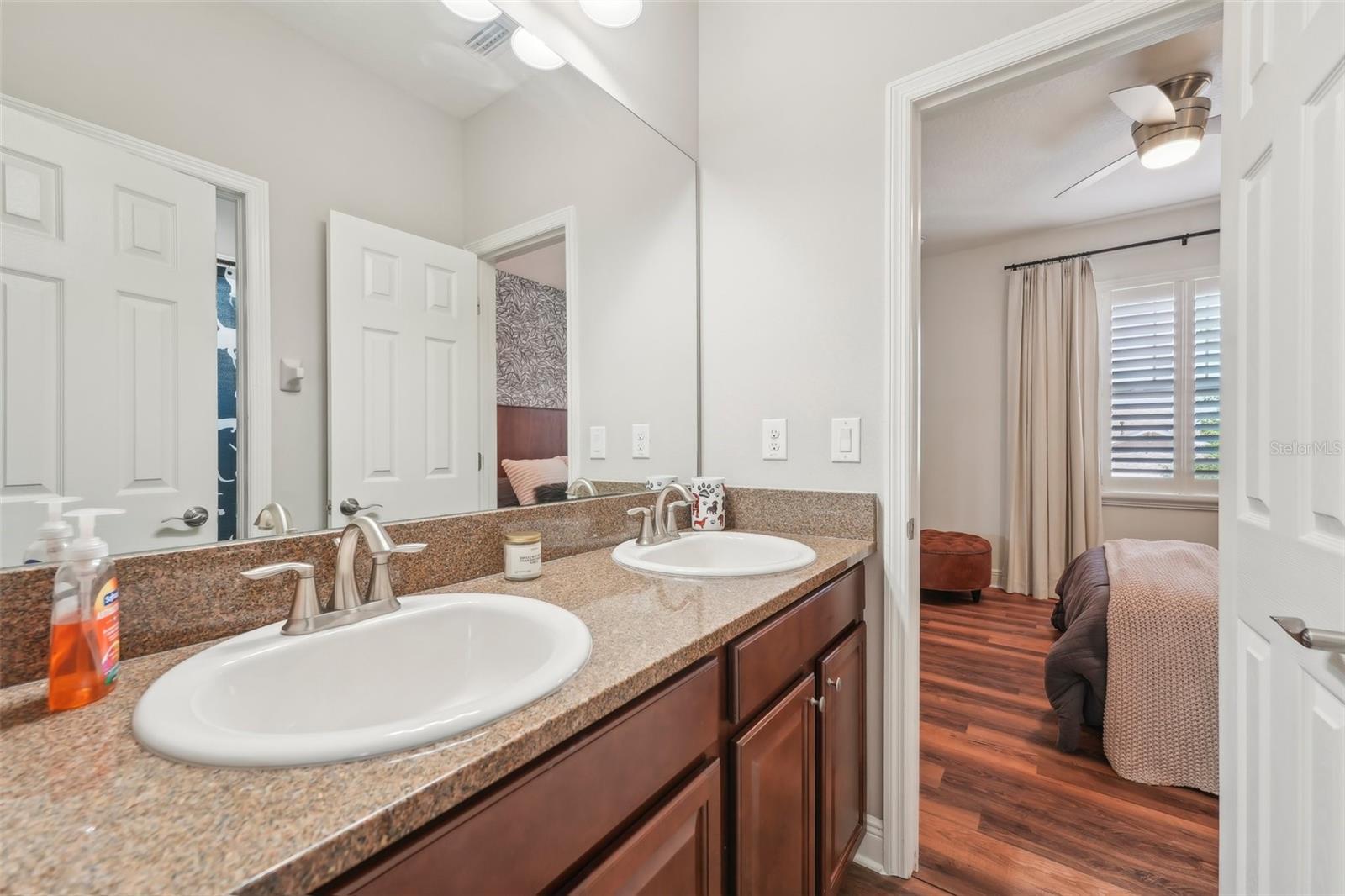 JACK & JILL BATHROOM BETWEEN BEDROOMS 2 AND 3 HAS DOUBLE SINK VANITY AND SEPARATE BATHTUB
