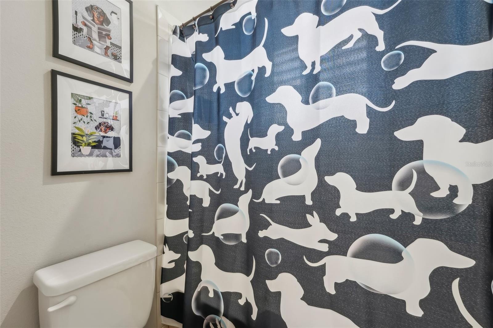 JACK & JILL BATHROOM BETWEEN BEDROOMS 2 AND 3 HAS DOUBLE SINK VANITY AND SEPARATE BATHTUB